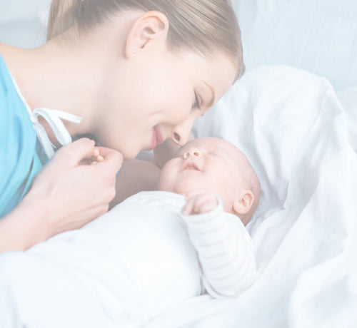 Mom snuggling newborn - Mustela USA - 1