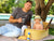 Image of dad sitting next to baby in a basket. Image also shows SPF 30 Mineral Sunscreen Spray