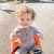 Image of baby holding sunscreen stick