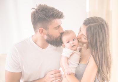 Parents kissing newborn - Mustela USA - 1