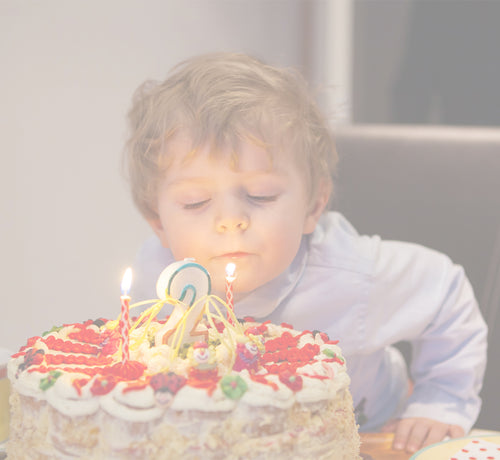 two year old blowing out birthday candles - Mustela USA - 1