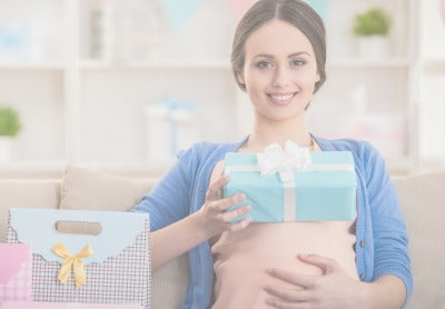 Woman opening presents during a baby shower  - Mustela USA - 1