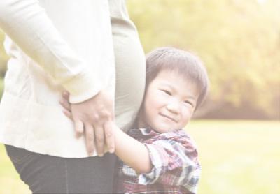 Woman on her second pregnancy with first child hugging her - Mustela USA - 1