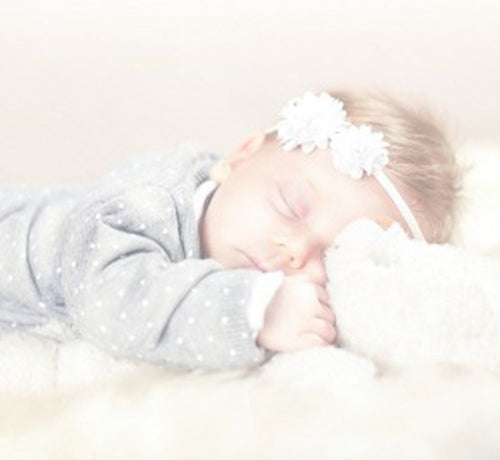 sleeping baby with a full head of baby hair - Mustela USA - 1