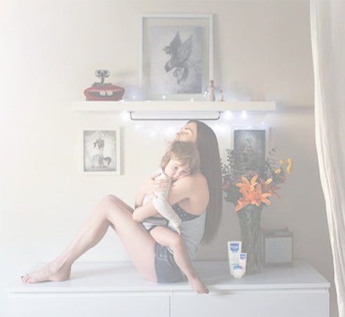Mom using ceramides for skin for child - Mustela USA - 1