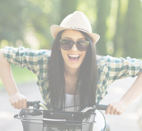 Woman riding bike while being protected by daily sunscreen - Mustela USA - 1