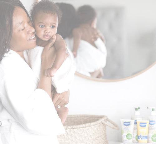 Mom learning how to dress baby for sleep - Mustela USA - 1