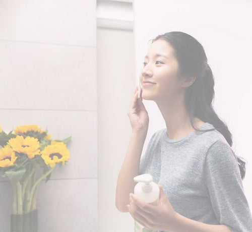 Woman applying non-nano zinc oxide sunscreen - Mustela USA - 1