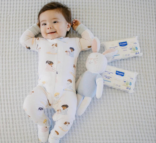 baby laying next to organic baby wipes - Mustela USA - 1