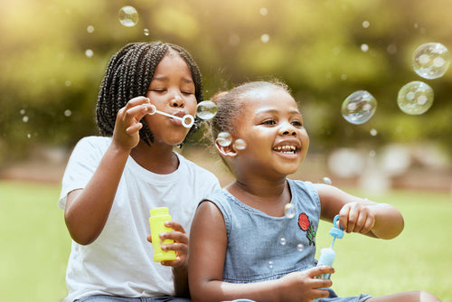 outdoor activities for toddlers - blowing bubbles - Mustela USA - 1