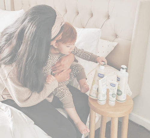 Mom using sustainable baby products - Mustela USA - 1