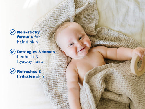 Smiling baby lying on a knitted beige blanket, holding a wooden ring, with blue text on the left side. - Mustela USA - 4