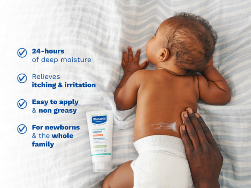 Parent applying Stelatopia Intense Eczema Relief cream on baby’s back, providing deep moisture and relieving itching. - Mustela USA - 2