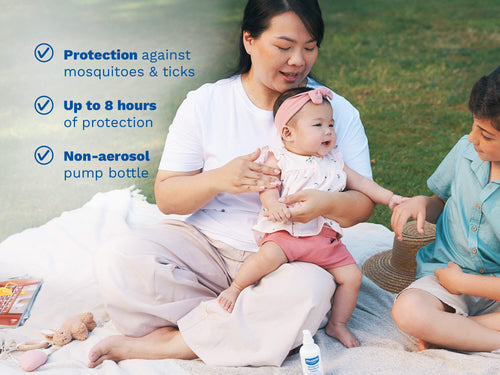 Mustela USA | A woman holds a smiling baby on her lap while sitting on a blanket in a park with an older child nearby. On the left, three checkmarked claims describe the Mustela Insect Repellent: protection against mosquitoes and ticks, up to 8 hours of protection, and a non-aerosol pump bottle - Mustela USA - 2