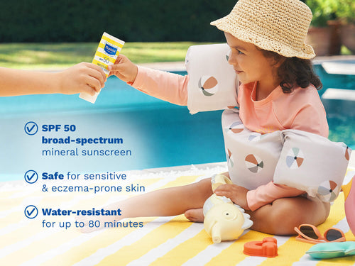 Mustela USA | Child at a poolside receiving sunscreen from an adult, with product details highlighted. - Mustela USA - 2