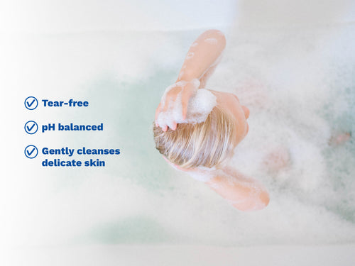 Child washing hair in bubble bath with gentle, tear-free formula benefits. - Mustela USA - 2
