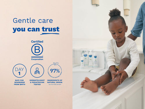 Mustela USA | Child sitting on a bathroom counter applying lotion to their legs. - Mustela USA - 5