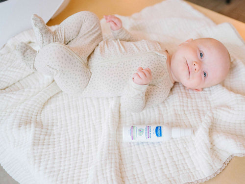 Mustela USA | Diaper Rash Sprayable Cream next to baby on a bed - Mustela USA - 3