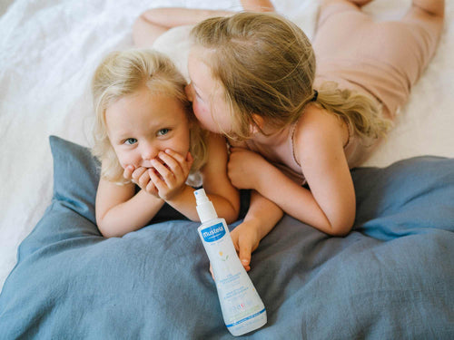 Mustela USA | Girls holding Hair Styler & Skin Freshener in a bed  - Mustela USA - 3