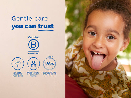 Smiling child sticking out tongue next to safety and certification icons. - Mustela USA - 6