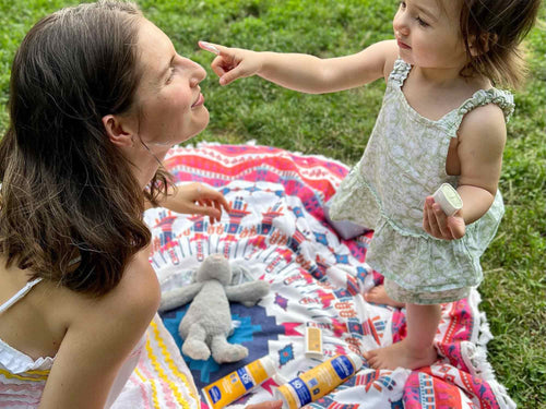 Mother and daughter playing on grassy field - Mustela USA - 4