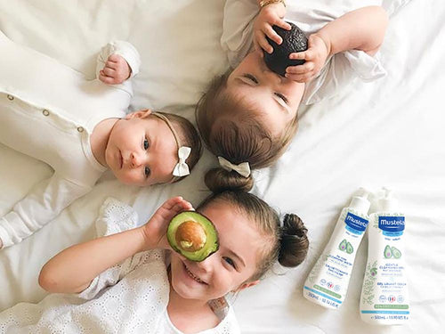 Mustela USA | Hydra Bebe Body Lotion pictured with children on a bed - Mustela USA - 2