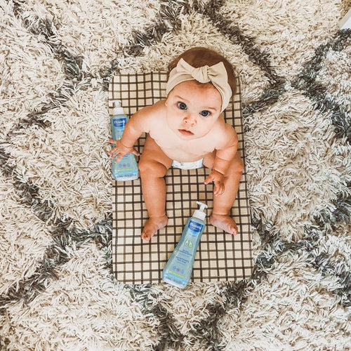 Mustela USA | Baby playing with No Rinse Cleansing Water on a rug - Mustela USA - 3