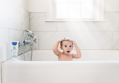 Baby in bath washing hair - Mustela USA - 3