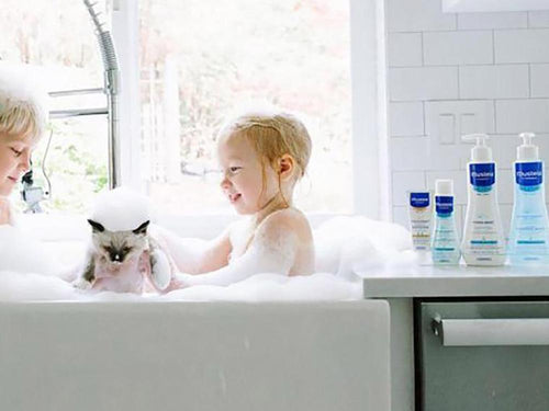 Mustela USA | Baby playing with Bath Bubbles in a bathroom - Mustela USA - 2