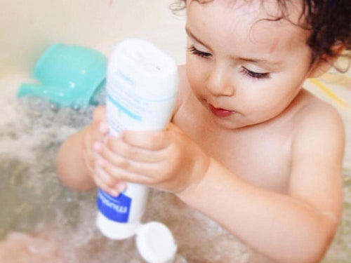 Mustela USA | Baby playing with a Multi Sensory Bubble Bath bottle - Mustela USA - 3