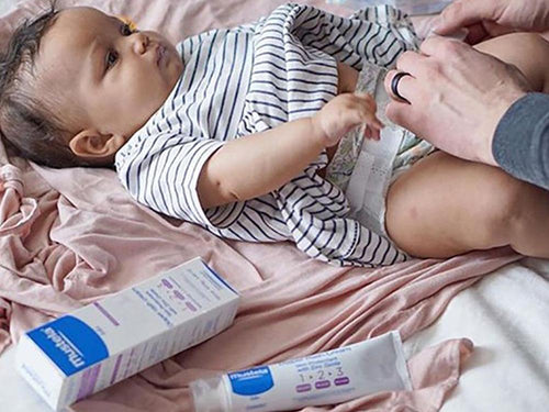 Mustela USA | Diaper Rash Cream 1 2 3 next to baby on a bed - Mustela USA - 3