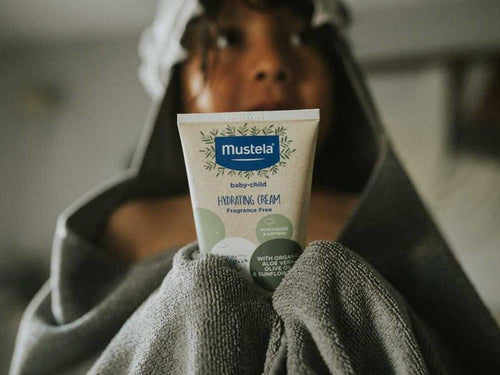 Child holding Organic Hydrating Cream with Olive Oil and Aloe - Mustela USA - 3